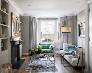 Traditional living room ideas in grey, with pale beige sofa and green and blue accents.