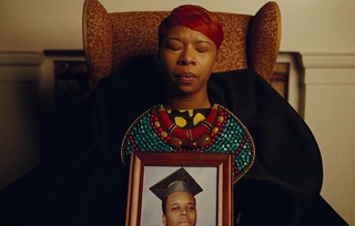 Mike Brown's mother holds a photo of him