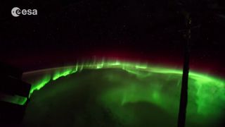 Shimmering green auroras dance over Earth in this stunning still image from a series of time-lapse videos of Earth from space by European Space Agency astronaut Alexander Gerst in 2014.