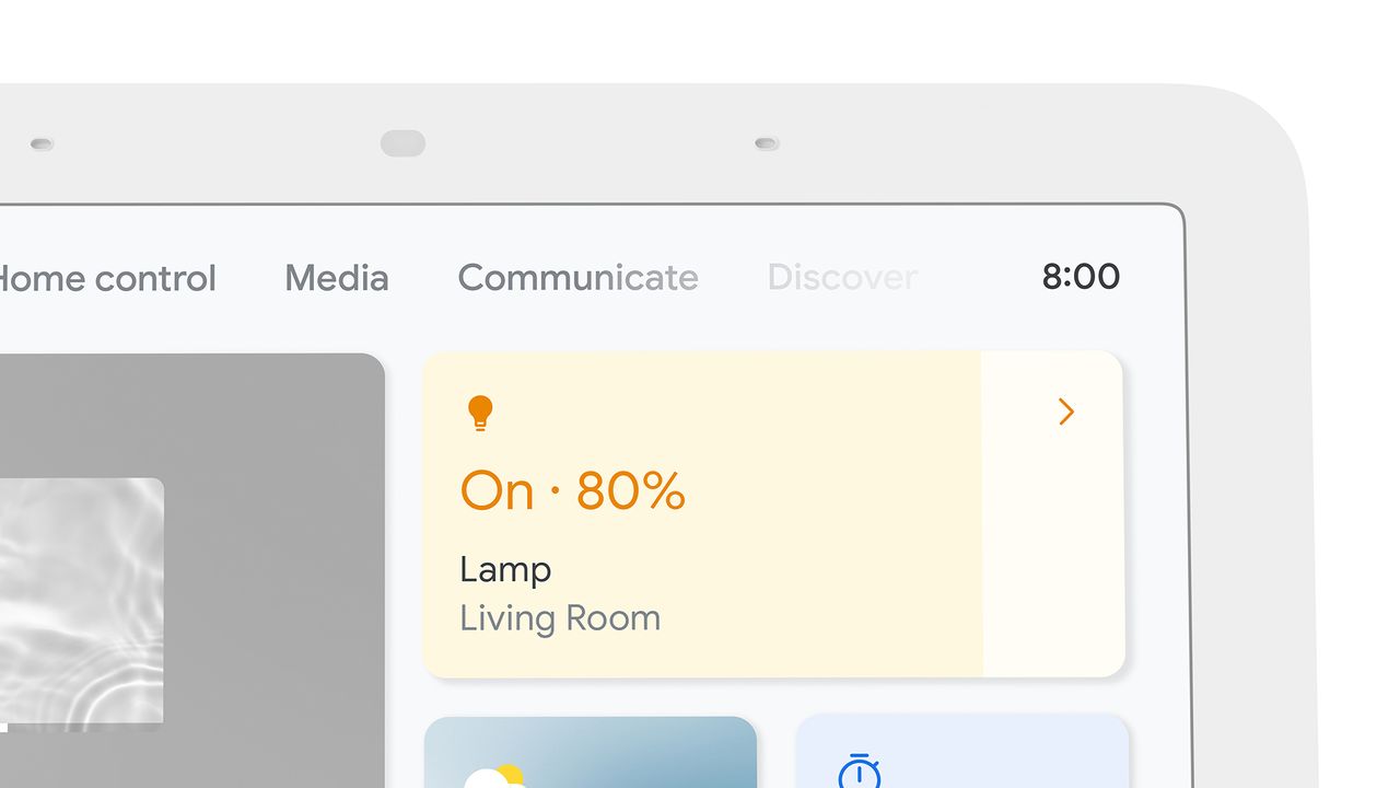 A close-up of the Google Nest Hub (2nd Generation) speaker. It shows the top portion of the screen with the time, some menu options and a panel for controlling a light set to 80%.
