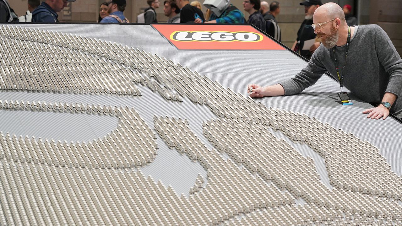 Lego designer Jens Kronvold Frederiksen places the final Stormtrooper on the record-breaking Lego Star Wars minifigure display at Star Wars Celebration in Chicago on April 11, 2019.