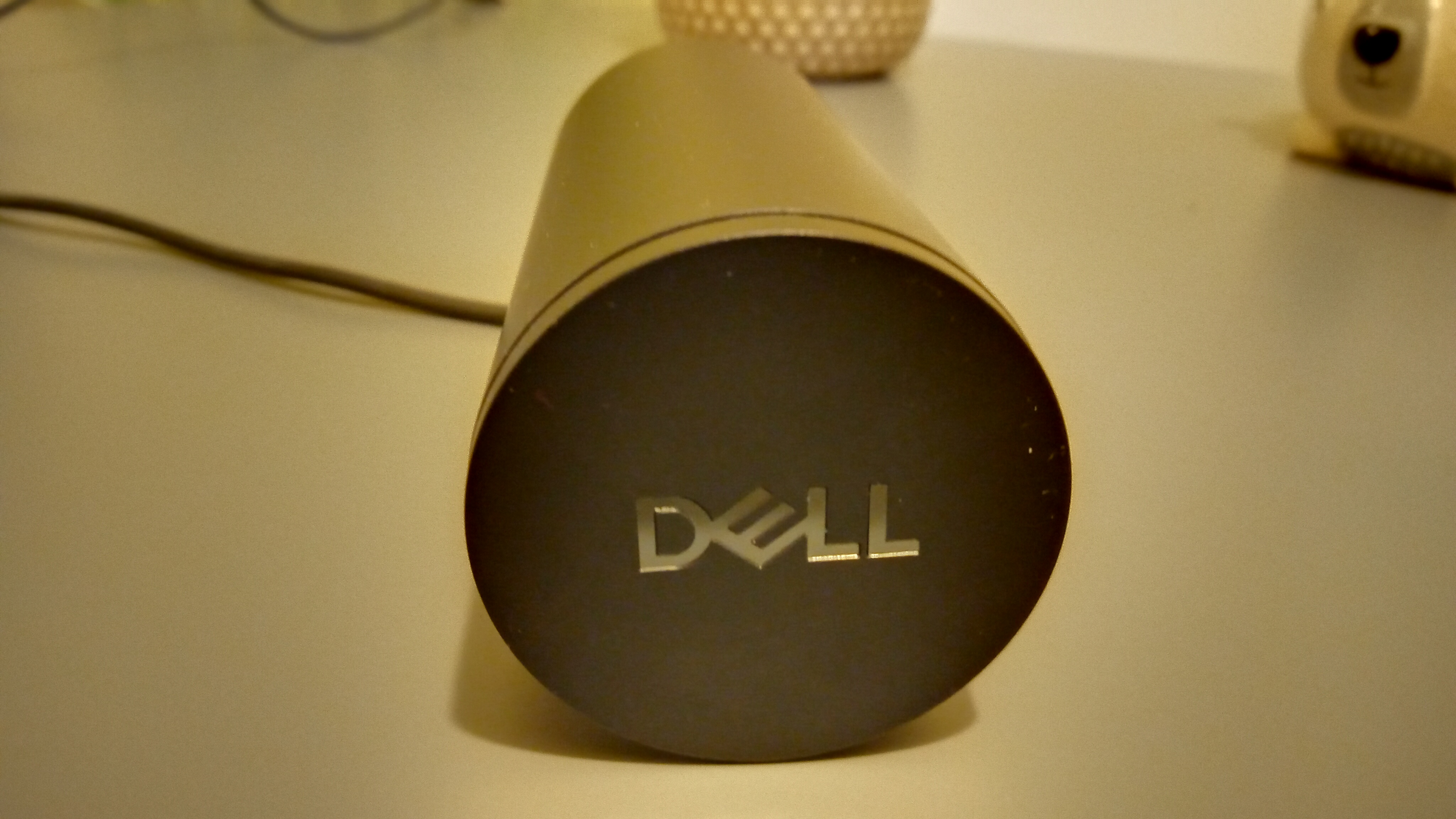 Une webcam Dell Pro noire posée sur une table grise et montée sur un ordinateur portable.