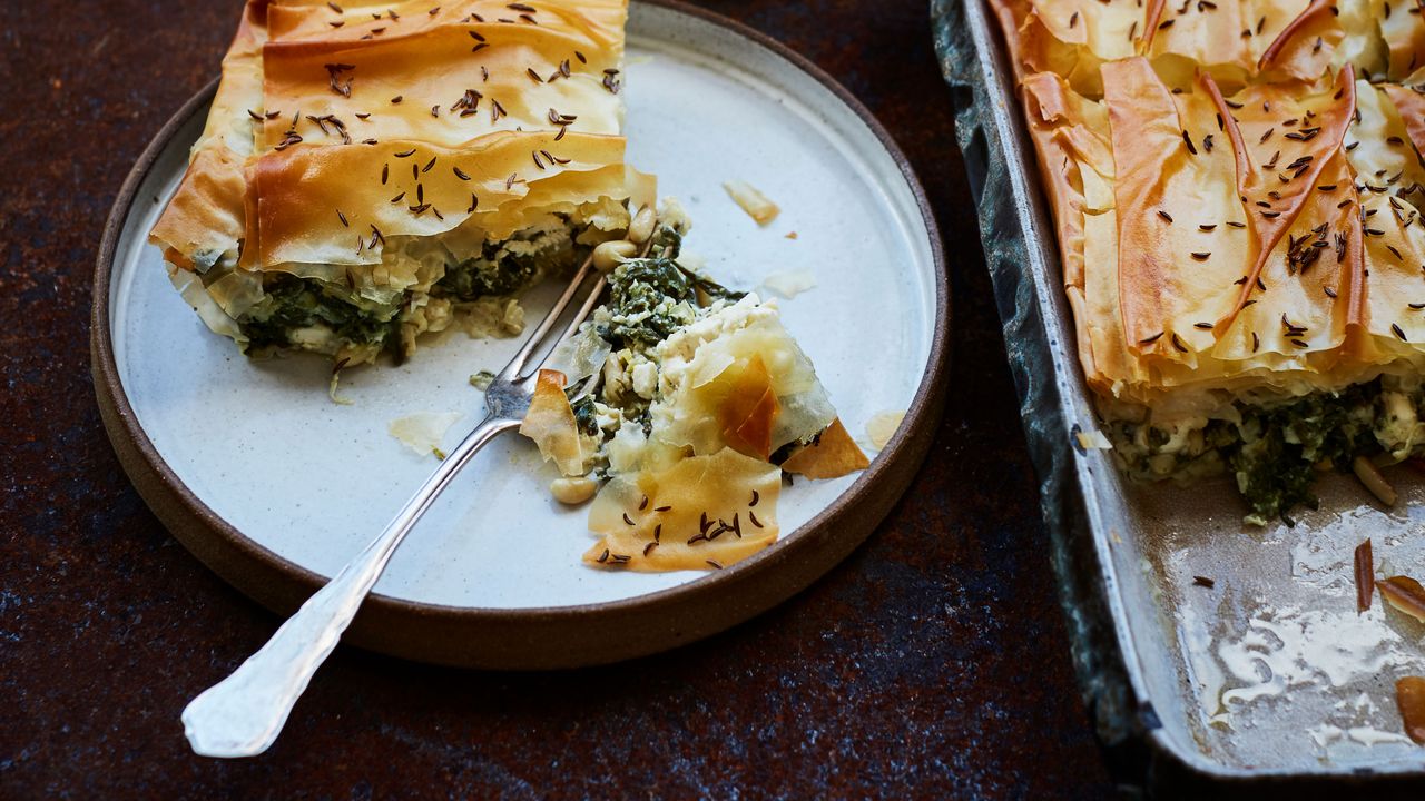 Spinach and Cheese Spanakopita with a portion on a plate beside