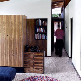 Bedroom with book shelves and brown cabinet
