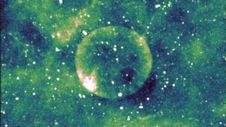 A green-hued image of a giant translucent sphere in space