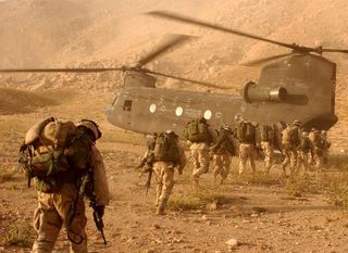Soliders approach the Chinook helicopter. The researchers' new model could help predict how plasma bubbles could affect future military operations.