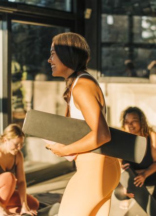 Woman holding a yoga mat