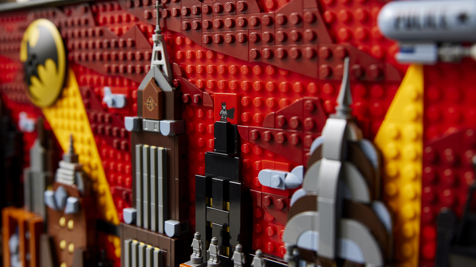 Lego Batman seen atop a skyscraper in Lego Gotham City