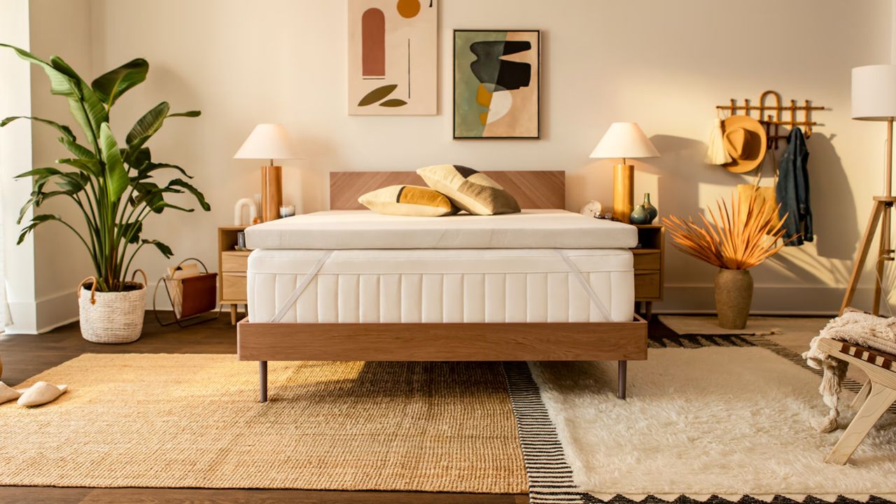 Looking for the best mattress topper? Here&#039;s the Tempur Mattress Topper on bed in beige boho bedroom with warm lighting