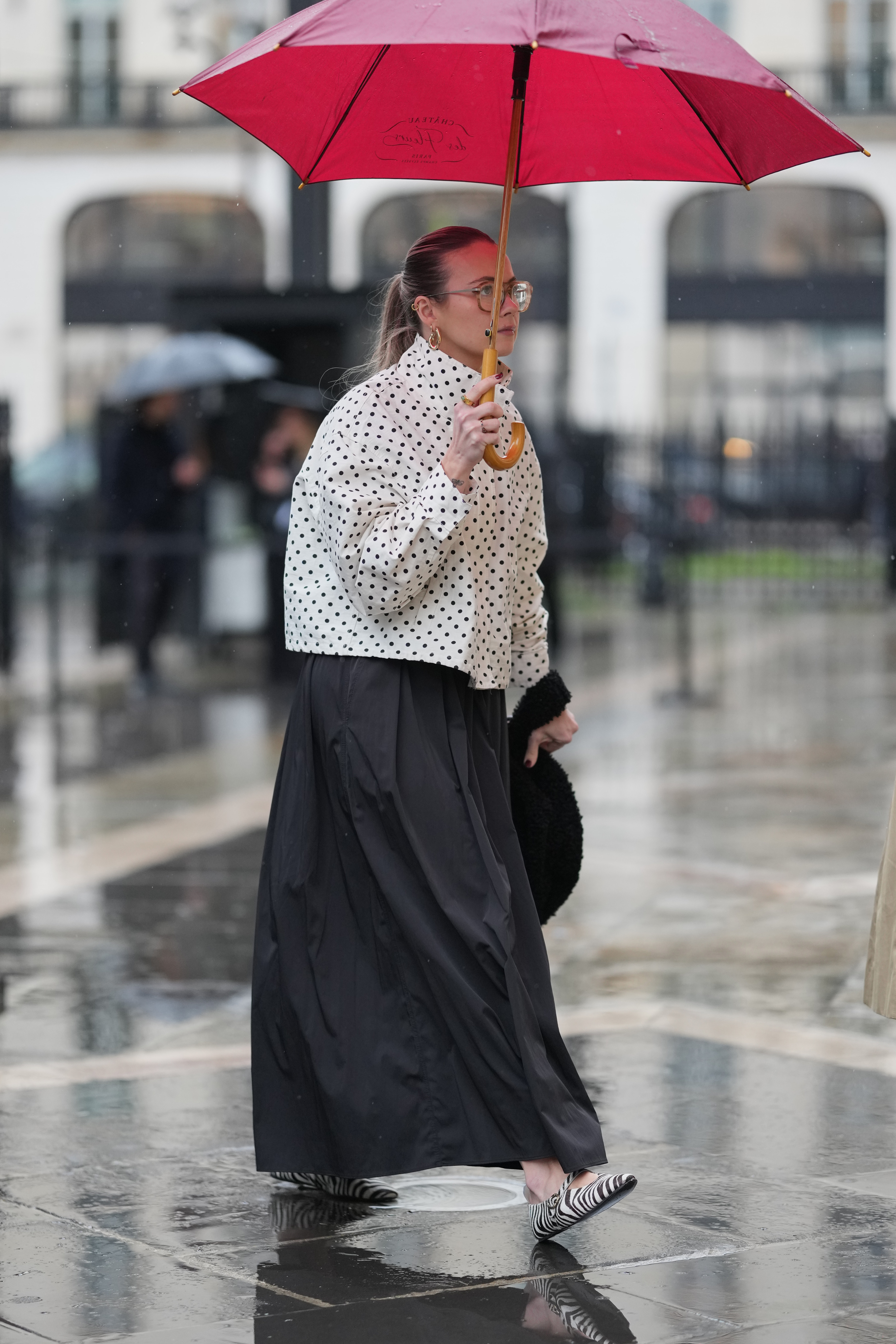 A guest wears a white shirt with black polka dots, a black maxi skirt, black and white zebra-print flats, during Paris Fashion Week - Haute Couture - Spring 2026, on January 27, 2026 in Paris, France.