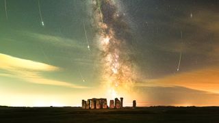 The Milky Way galaxy glows over the rock structure of Stonehenge.
