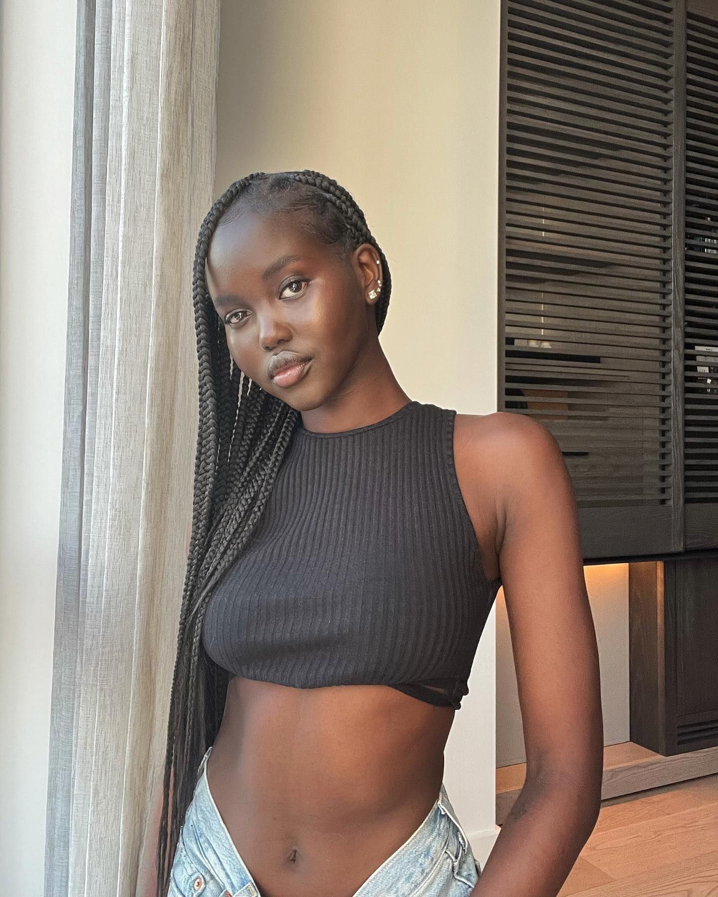 Adut Akech with side swept braids