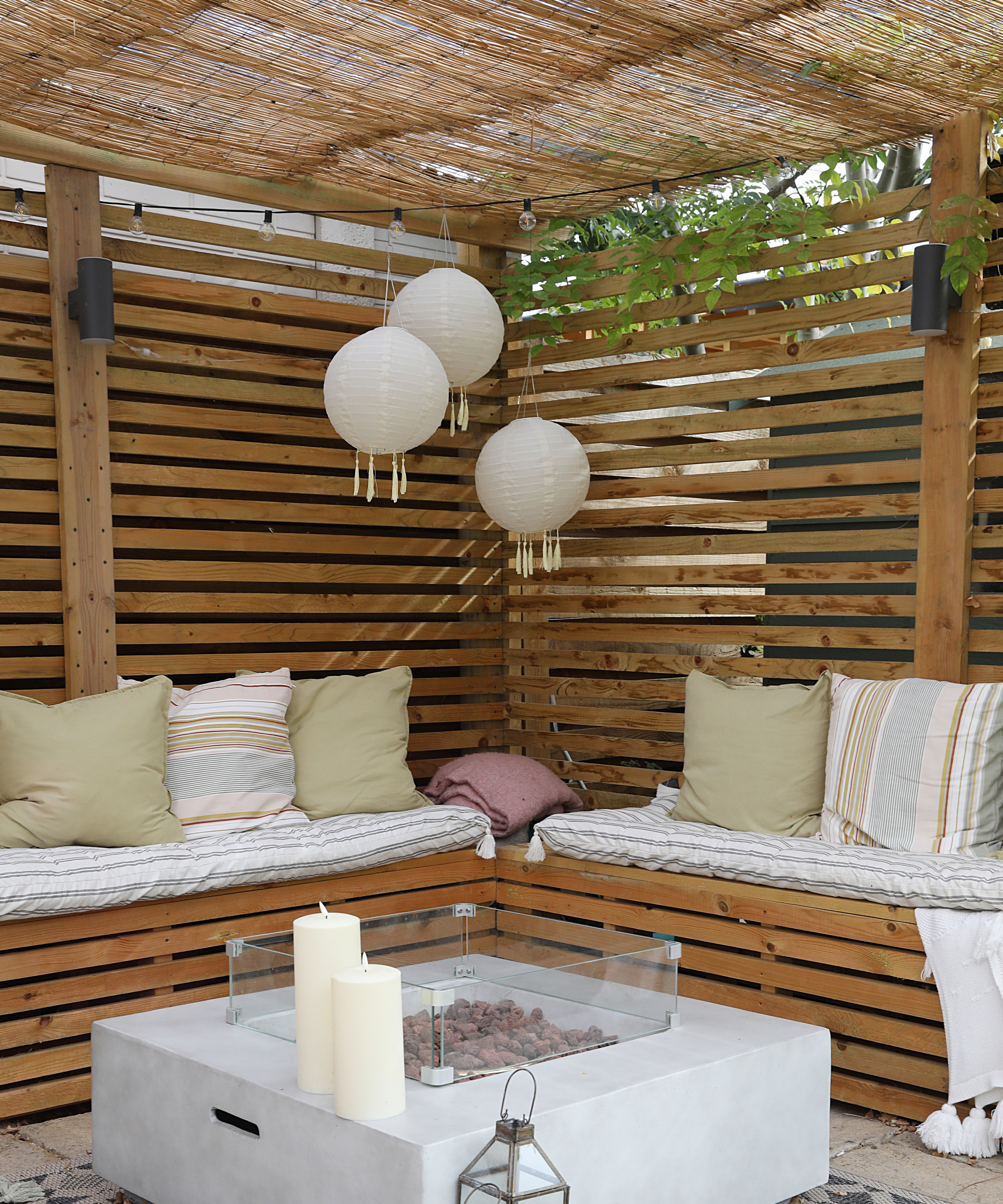 garden pergola with hanging pendant lights and outdoor fire bowl