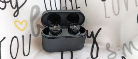 1More PistonBuds Pro wireless earbuds being displayed on a pillow