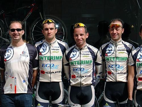 Team Whistle riders and support staff pose in front of a Whistle Bikes dealer during a publicity tour before the Giro di Terra d'Otranto