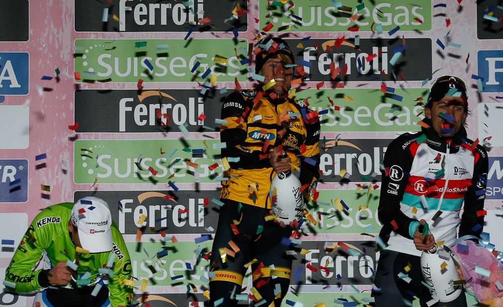German Gerald Ciolek sprays Champagne next to Peter Sagan and Fabian Cancellera on the podium after the104th Milan-San Remo