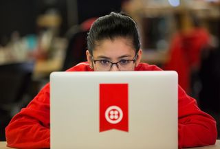 Twilio laptop with lady sat behind it