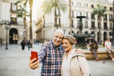 A couple takes a selfie in Barcelona.