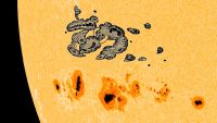 Photo of giant sunspots on the sun with a sketch of the Carrington sunspot added for comparison 