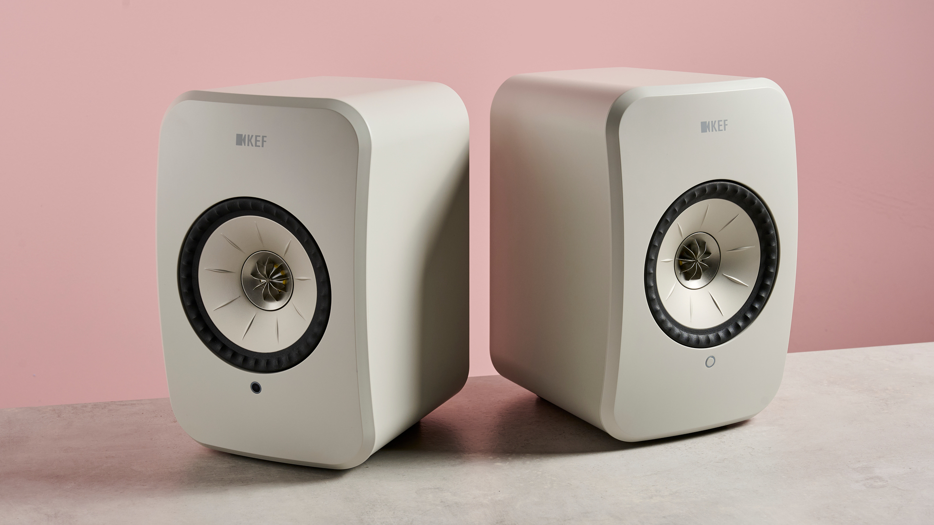 The KEF LSX II LT speaker against a pink background