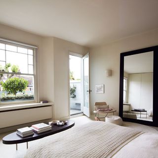 Master bedroom with large mirror