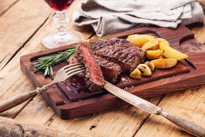 steak and chips on a board