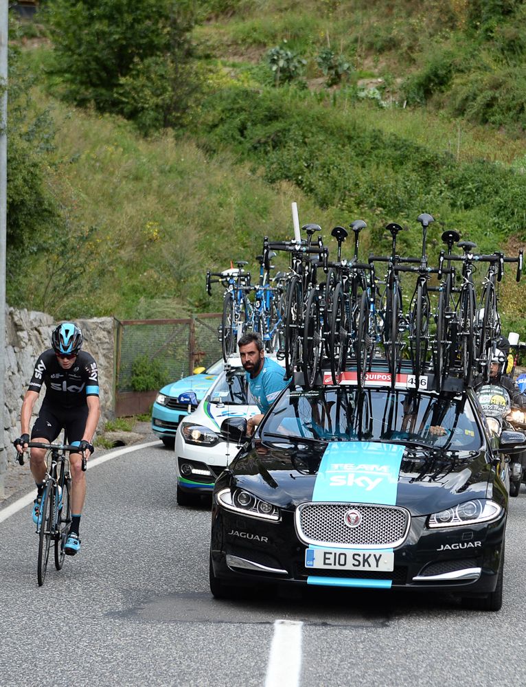 Chris Froome struggles alongside the Sky team car during stage 11 of the 2015 Vuelta a Espana.