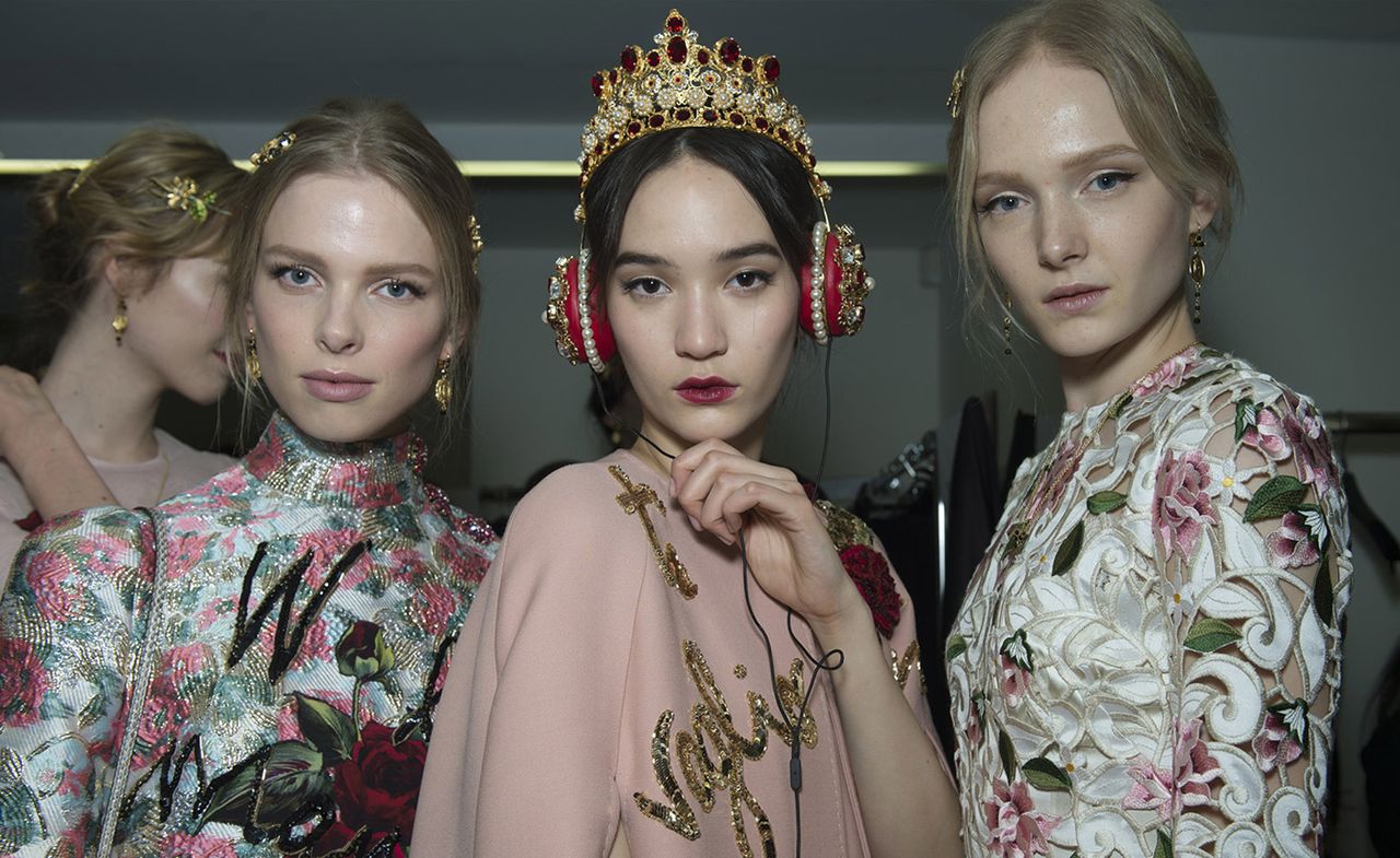 Models wearing colorful dresses with floral patterns and golden hairpiece elements, from Dolce &amp; Gabbana A/W 2015 collection.