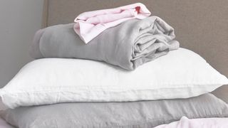 Scooms double linen sheets, piled up