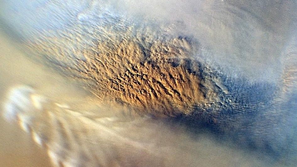 A brown cloud looming over a tan landscape