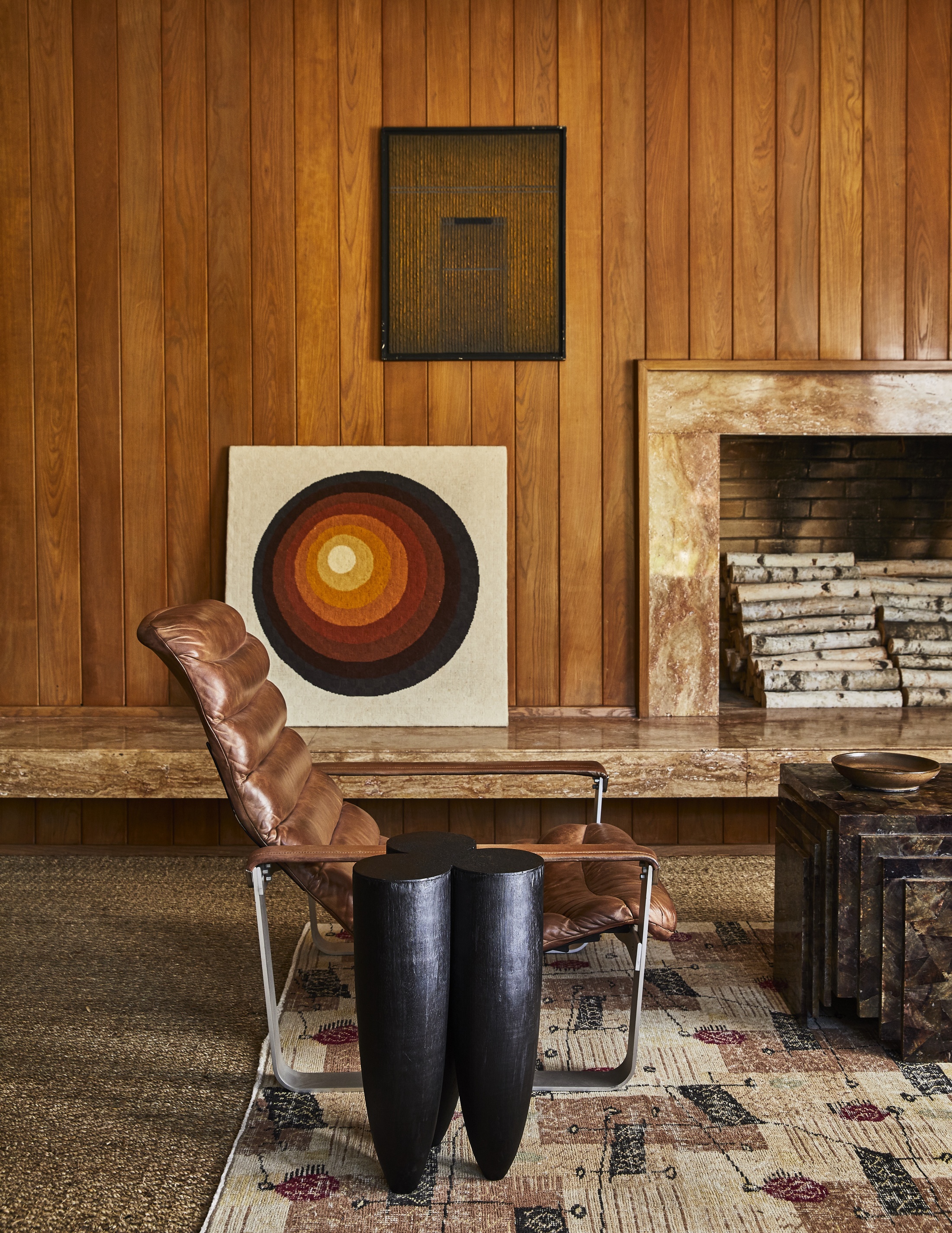 living room with brown leather chair and wood clad walls