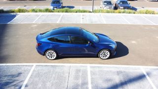 Side view of the Tesla Model 3 in a parking lot