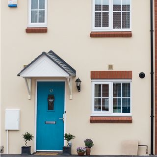 exterior with blue door with sash window