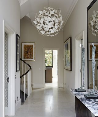 A modern hallway idea with contemporary globe chandelier made from white butterflies