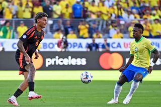 Richard Rios of Colombia (L) plays against Vinicius Júnior of Brazil (R) during the CONMEBOL Copa America USA Group Stage match between Brazil and Colombia at Levi's Stadium on July 2, 2024 in Santa Clara, California.