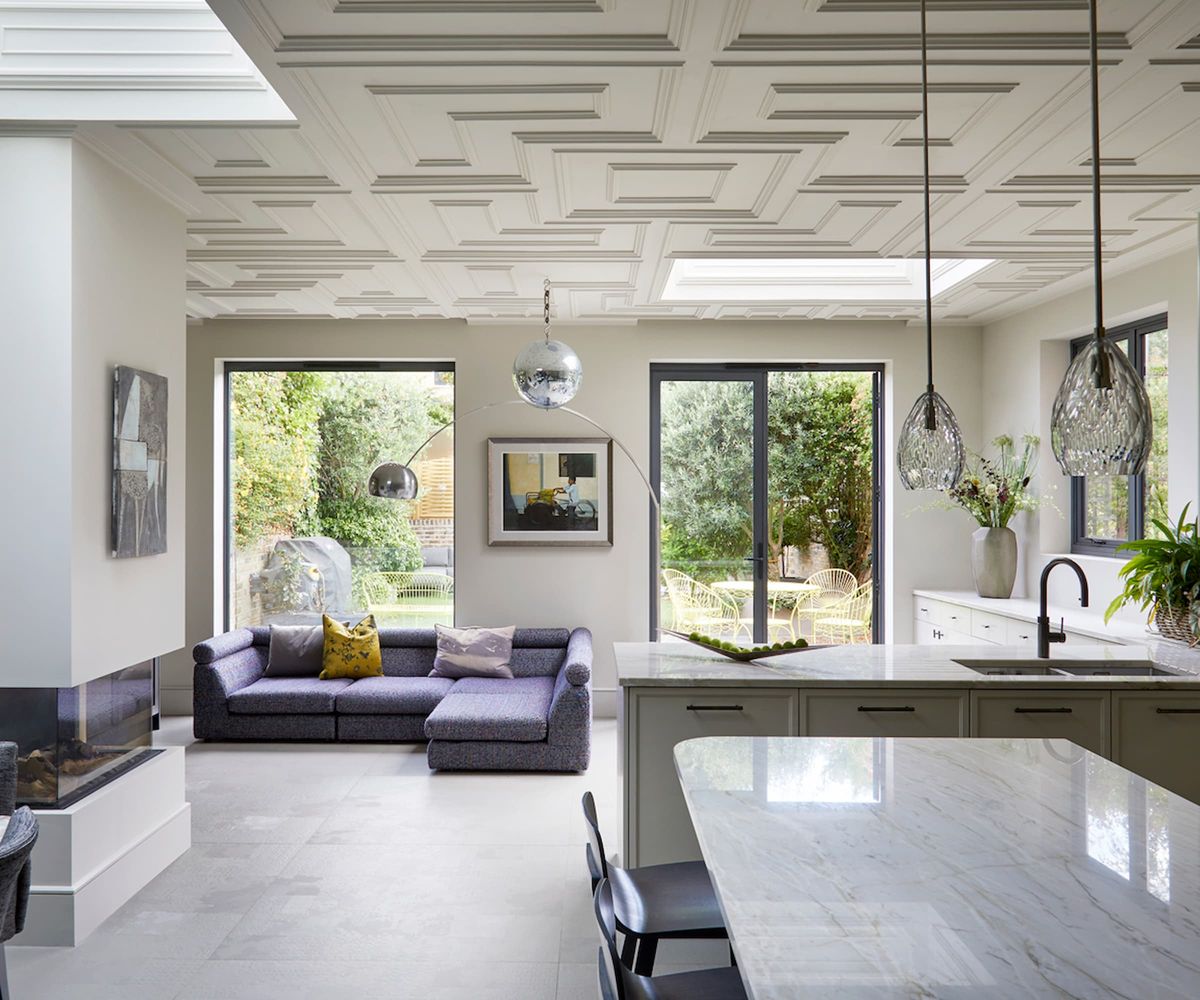 A kitchen with an artex ceiling and two skylights