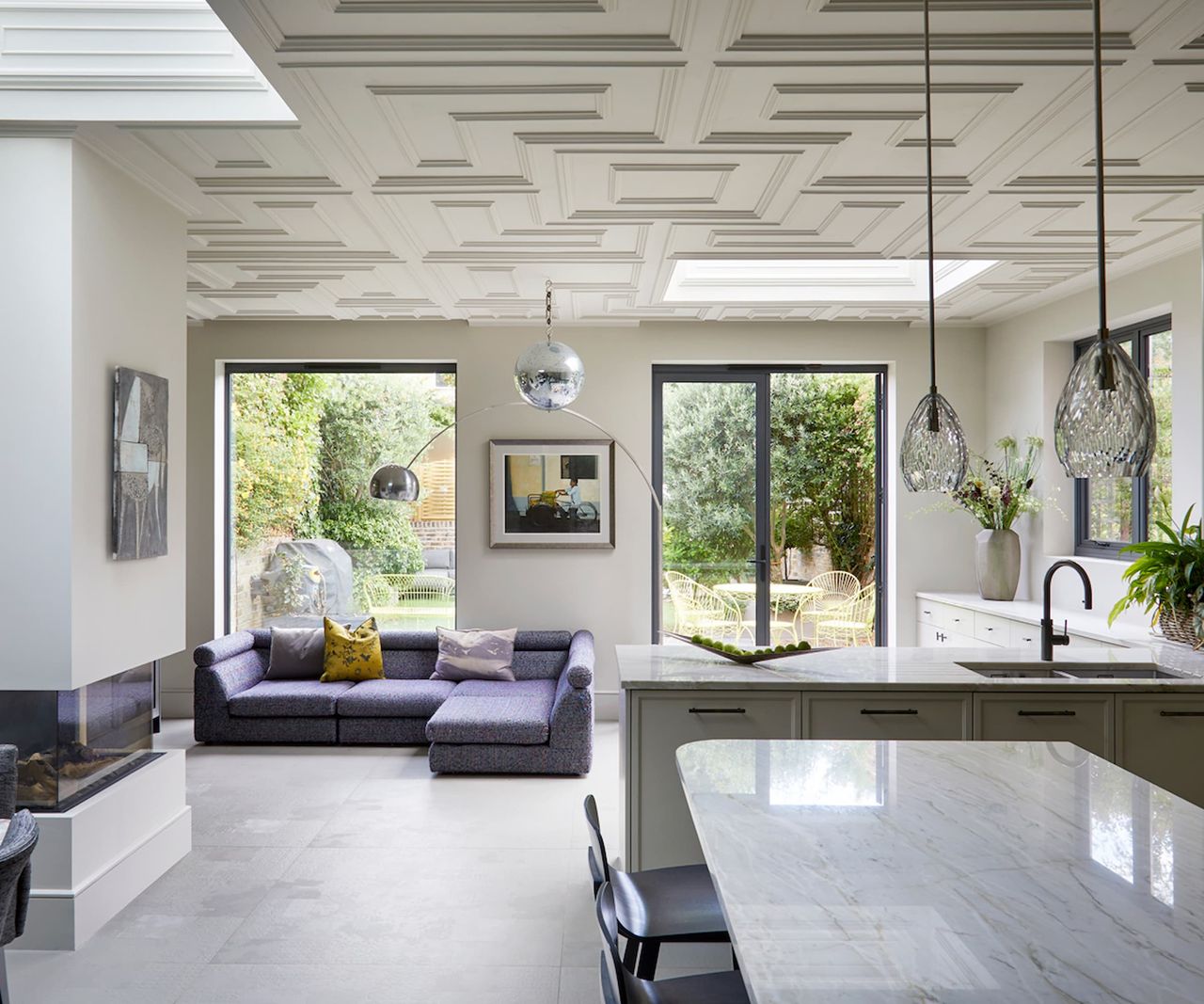 A kitchen with an artex ceiling and two skylights