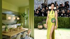 There is a table wooden table in a green tiled kitchen with three lights hanging over it. The floor is chequered black and white and on the table there are Apples, a carafe and plants.