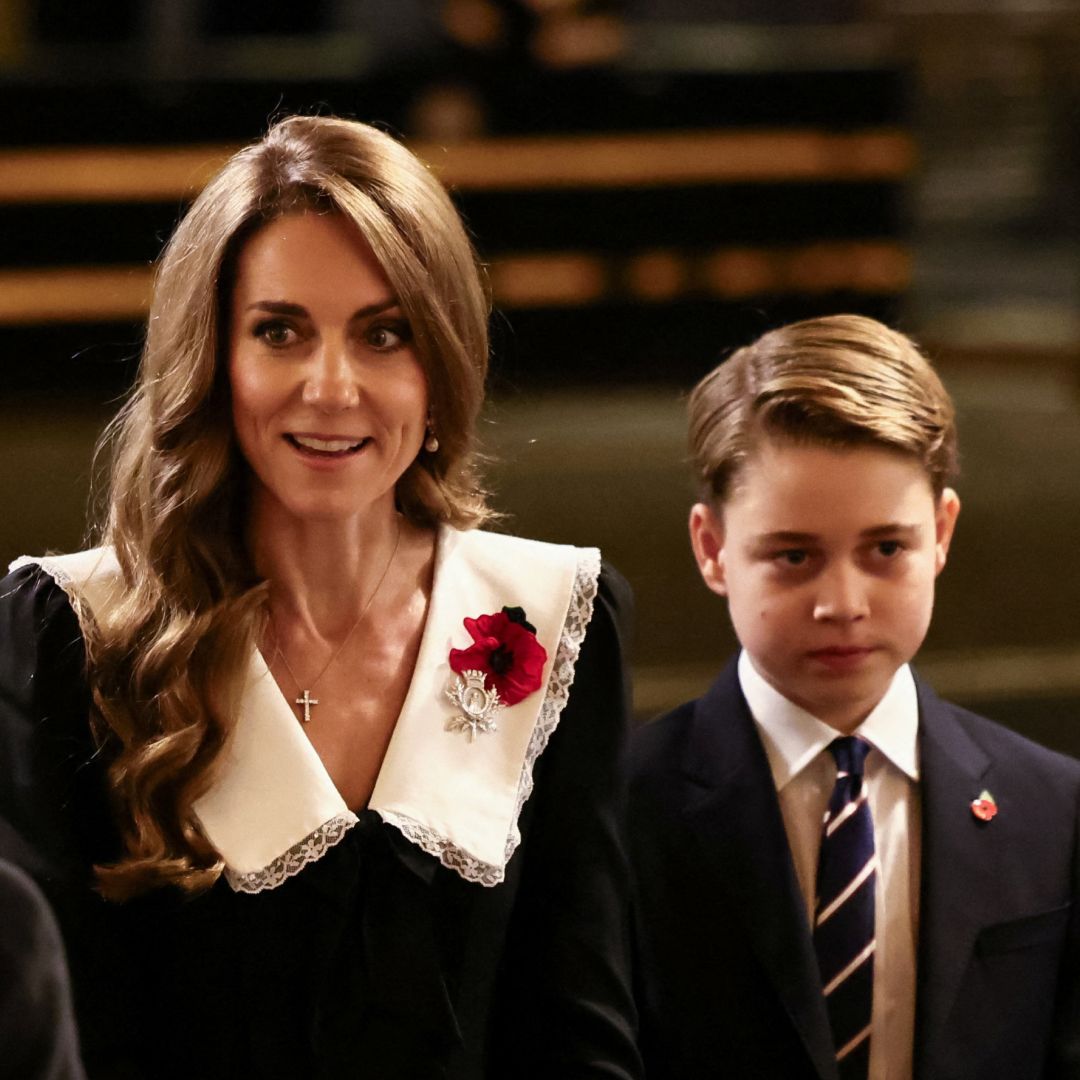 Kate Middleton wears a black dress with a large white collar and is accompanied by eldest son Prince George at the Royal British Legion Festival of Remembrance at the Royal Albert Hall in London