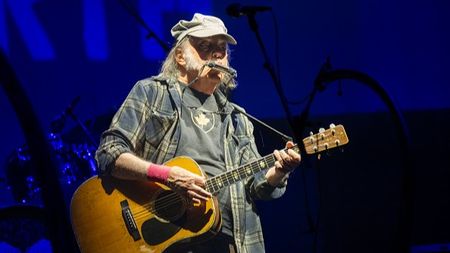 Neil Young performing at Glastonbury festival in 2025