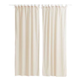 A minimalist pair of curtains in light beige