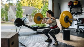 Woman working out with weights in garage