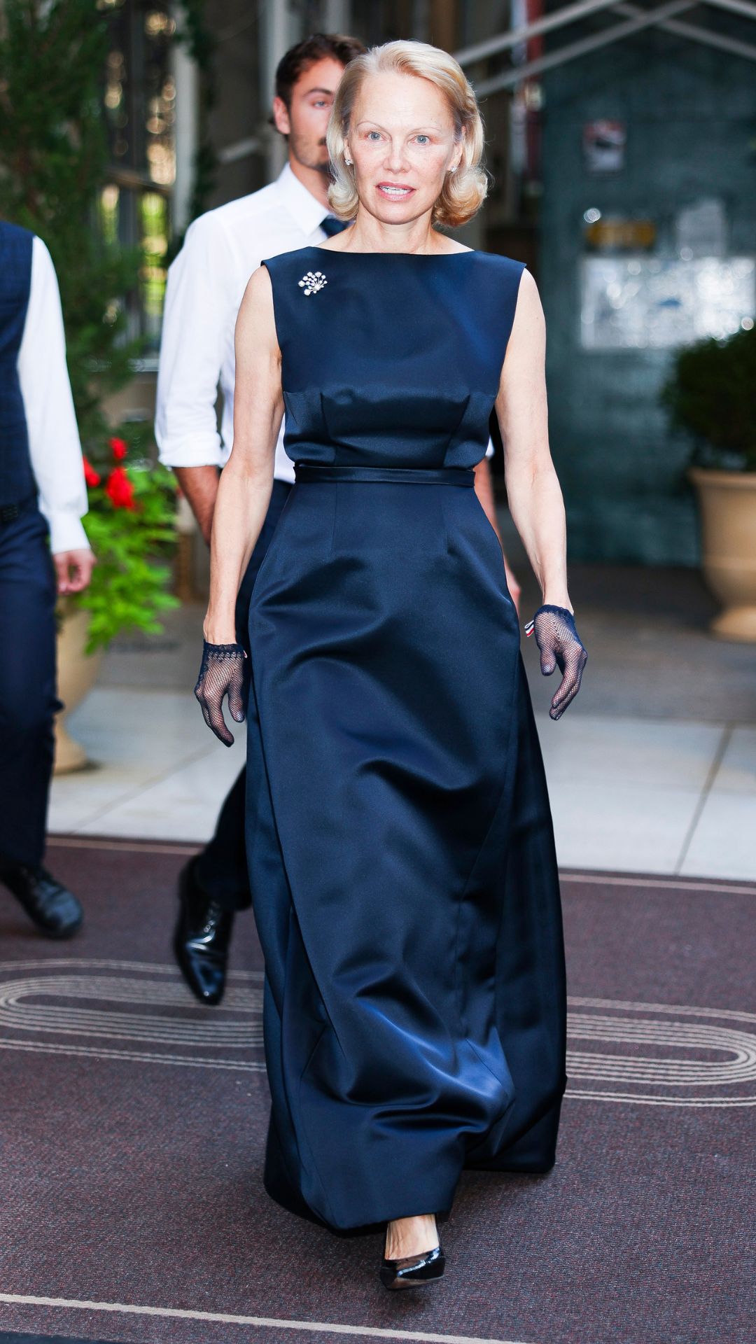 PAMELA ANDERSON WEARING A NAVY DRESS