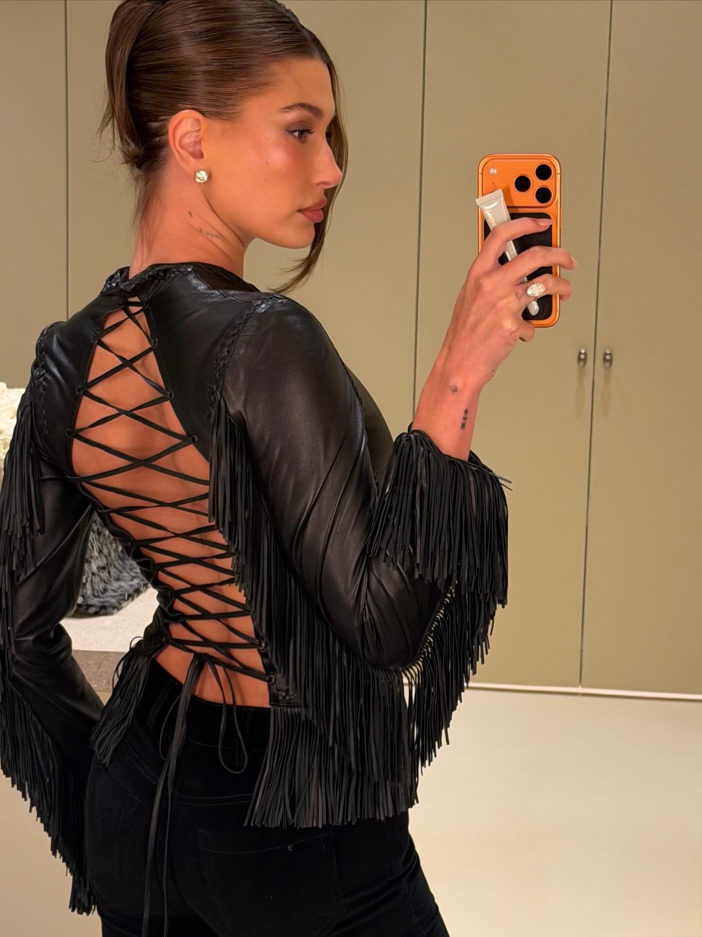 Hailey Bieber wearing diamond stud earrings