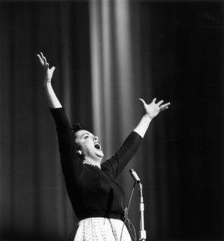 Black and white photo of a woman singing