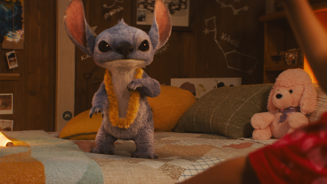 Stith on a bed with a Hawai&#039;ian lei around his neck in Lilo &amp; Stitch