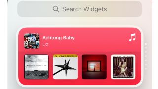 Musikkprogrammet på en iPhone viser en oversikt over U2-album