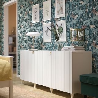 Living room with wallpaper and white storage unit