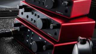 Three Focusrite Scarlett 4th Gen audio interfaces stacked on top of each other in a studio