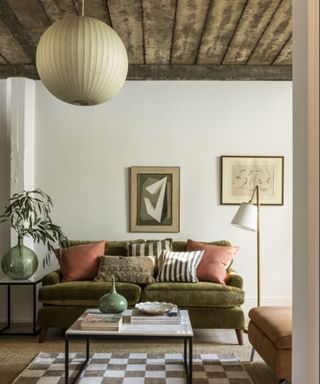 Green, brown and white living room with checkered rug and green sofa